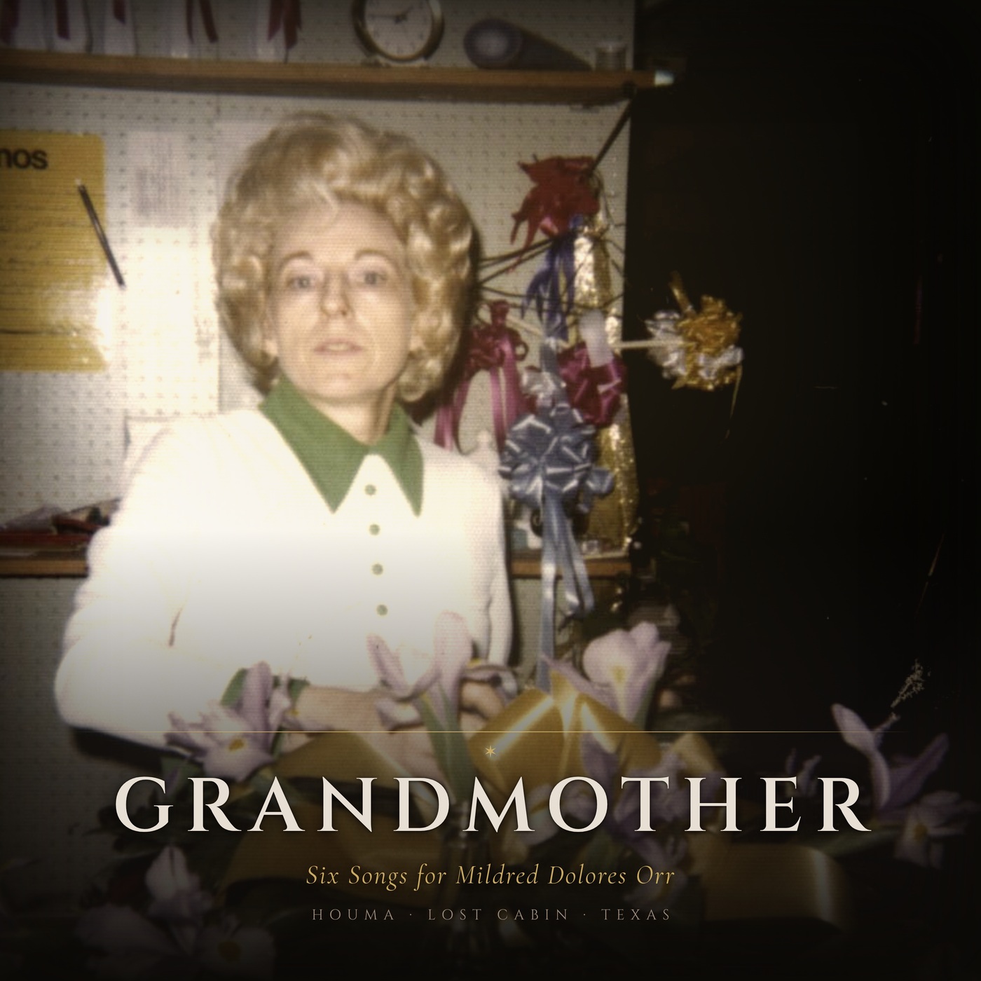 Album cover: Mildred Dolores Orr standing behind an arrangement of purple irises tied with gold ribbon in her flower shop in Houma, Louisiana. The title reads Grandmother.